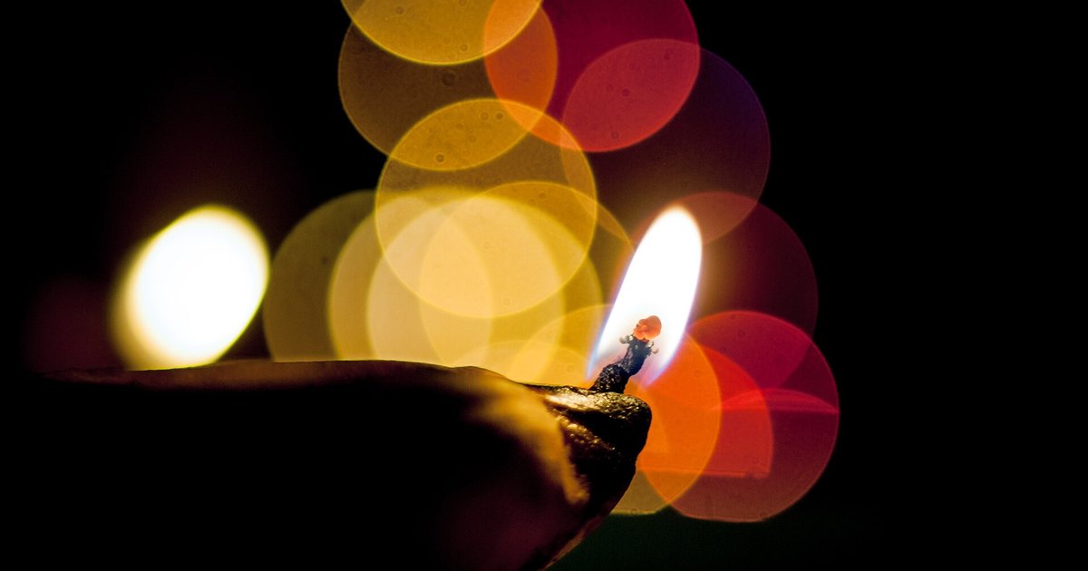 Lit earthen diya oil lamp glowing in the dark during Diwali